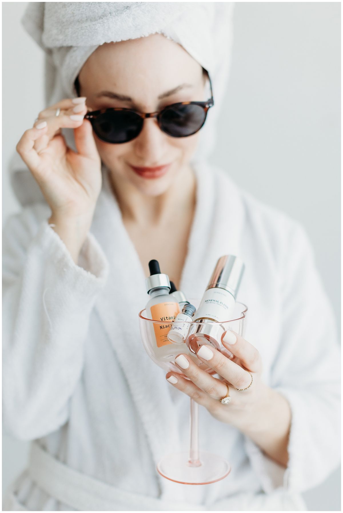 Skincare content shot in a robe and sunglasses