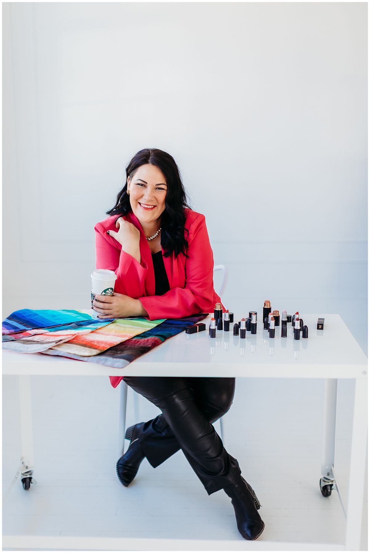 Business owner planning at a table of swatches and lipsticks